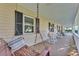 Cozy porch seating with hanging swing, rocking chairs, and views of the front yard at 5108 Waterwood Dr, Bartow, FL 33830