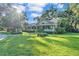 Beautifully landscaped front yard with a spacious lawn and mature trees at 5108 Waterwood Dr, Bartow, FL 33830