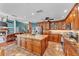 Open kitchen featuring wood cabinets, a granite island, and modern stainless steel appliances at 5108 Waterwood Dr, Bartow, FL 33830