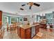 Open-concept kitchen and dining area with an island and stainless steel dishwasher at 5108 Waterwood Dr, Bartow, FL 33830