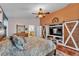 Main bedroom featuring hardwood floors, an orange accent wall and barn door accents at 5108 Waterwood Dr, Bartow, FL 33830
