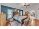 Comfortable main bedroom featuring wood floors, a blue accent wall and a charming decor at 5108 Waterwood Dr, Bartow, FL 33830