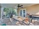 Screened patio has brick pavers, ceiling fan and dining table at 5108 Waterwood Dr, Bartow, FL 33830