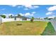 Expansive backyard with lush green grass and secure fencing, offering ample space for recreation and privacy at 5458 Oakford Dr, Lakeland, FL 33812
