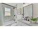 Well-lit bathroom offering a tub, shower, and vanity with contemporary fixtures and finishes at 5458 Oakford Dr, Lakeland, FL 33812