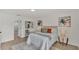 Cozy bedroom showcasing modern décor, wood flooring, and convenient access to the ensuite bathroom at 5458 Oakford Dr, Lakeland, FL 33812