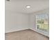 Bright bedroom with wood floors, featuring a window offering outdoor views at 5458 Oakford Dr, Lakeland, FL 33812