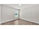 Bright bedroom with neutral walls, wood flooring and a window at 5458 Oakford Dr, Lakeland, FL 33812