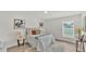 Comfortable bedroom featuring neutral tones, stylish decor, and natural light from a bright window at 5458 Oakford Dr, Lakeland, FL 33812