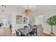 Open-concept dining area with views of kitchen and living area, featuring stylish pendant lighting and modern decor at 5458 Oakford Dr, Lakeland, FL 33812