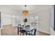 Bright dining room features wood floors, a contemporary light fixture, and a view of the front yard at 5458 Oakford Dr, Lakeland, FL 33812