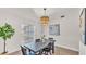 Well-lit dining area with a view of the backyard, complete with an elegant pendant light fixture at 5458 Oakford Dr, Lakeland, FL 33812