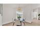 Bright dining area with a circular table, stylish chairs, and a window offering a glimpse of the outdoors at 5458 Oakford Dr, Lakeland, FL 33812