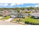 Beautifully landscaped single-Gathering home in a quiet neighborhood with lush green lawn and mature trees at 5458 Oakford Dr, Lakeland, FL 33812