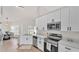 Well-lit kitchen with stainless steel appliances, modern white cabinetry and luxury countertops at 5458 Oakford Dr, Lakeland, FL 33812
