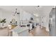 Contemporary kitchen featuring white cabinets, stainless steel appliances, and an open view to the living area at 5458 Oakford Dr, Lakeland, FL 33812