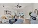 Bright, open living room featuring wood floors, modern ceiling fan, and lots of natural light at 5458 Oakford Dr, Lakeland, FL 33812
