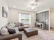 Cozy living room with a large sectional sofa, ottoman, and modern entertainment center at 5768 Anders Way, St Cloud, FL 34771