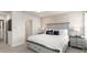 Serene main bedroom with a decorative accent wall, neutral color scheme, and stylish furnishings at 5774 Anders Way, St Cloud, FL 34771