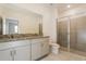 Modern bathroom features a dual sink vanity, a glass-enclosed shower, and tiled floors at 606 Fairview Ave # 244, Haines City, FL 33844