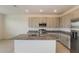 Stylish kitchen features stainless steel appliances, granite counters, and light gray cabinets at 606 Fairview Ave # 244, Haines City, FL 33844