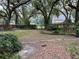 Expansive back yard with mature trees and a charming bench, creating a serene outdoor space at 6116 Sweet Gum Run, Bartow, FL 33830