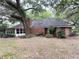 The rear of the house features a brick chimney and a enclosed back porch at 6116 Sweet Gum Run, Bartow, FL 33830