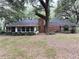 The rear of the house features a brick chimney and a enclosed back porch at 6116 Sweet Gum Run, Bartow, FL 33830