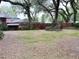 Spacious backyard with mature trees and a sturdy, fenced perimeter at 6116 Sweet Gum Run, Bartow, FL 33830
