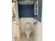 Toilet in bathroom with white beadboard paneling and dark blue walls at 6116 Sweet Gum Run, Bartow, FL 33830