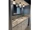 Bathroom featuring granite counters, a tile backsplash, and decorative lighting at 6116 Sweet Gum Run, Bartow, FL 33830
