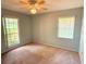 Cozy bedroom with a ceiling fan and a view from two large windows at 6116 Sweet Gum Run, Bartow, FL 33830