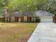 Charming brick home with a well-manicured lawn and mature trees creating a lovely curb appeal at 6116 Sweet Gum Run, Bartow, FL 33830
