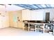 Garage with workspace and storage, including shelving and wall cabinets at 6116 Sweet Gum Run, Bartow, FL 33830