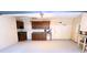 Spacious garage featuring ample cabinet storage, pegboard wall, and painted floor at 6116 Sweet Gum Run, Bartow, FL 33830