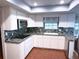 Updated kitchen features granite countertops, stainless steel appliances, and bright, recessed lighting at 6116 Sweet Gum Run, Bartow, FL 33830