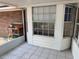 Enclosed brick lanai with tile floor, looking outside to a potting bench at 6116 Sweet Gum Run, Bartow, FL 33830