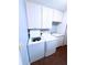 Laundry room with full sized washer, dryer and plenty of cabinets for extra storage at 6116 Sweet Gum Run, Bartow, FL 33830