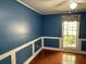 Living room features wainscotting, wood floors, and a bright window at 6116 Sweet Gum Run, Bartow, FL 33830