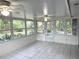 Enclosed porch with tile flooring, ceiling fans, and an abundance of natural light at 6116 Sweet Gum Run, Bartow, FL 33830