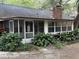 Exterior view of the rear of the home, showing the screened in porch and landscaping at 6116 Sweet Gum Run, Bartow, FL 33830