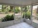 An open-air screened porch to enjoy the tropical backyard garden at 6116 Sweet Gum Run, Bartow, FL 33830