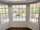 Bright sunroom featuring three large windows, white trim, and brick floor at 6116 Sweet Gum Run, Bartow, FL 33830