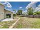 Expansive backyard with stepping stones, wood privacy fence, and plenty of room to entertain or relax at 6338 Oak E Sq, Lakeland, FL 33813
