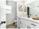 A bathroom has white cabinets, black hardware, and a speckled white countertop at 6338 Oak E Sq, Lakeland, FL 33813