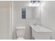 Simple utility bathroom with white fixtures and clean, minimalist design elements at 6338 Oak E Sq, Lakeland, FL 33813