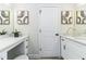 A bathroom has dual vanities with white countertops, cabinets and black hardware at 6338 Oak E Sq, Lakeland, FL 33813