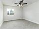 Bright bedroom with neutral walls, plush gray carpet, and a modern ceiling fan at 6338 Oak E Sq, Lakeland, FL 33813