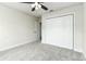Bedroom featuring soft gray carpet and a closet with sleek, white bi-fold doors at 6338 Oak E Sq, Lakeland, FL 33813