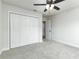 Clean bedroom featuring gray carpet and a spacious closet with sliding doors at 6338 Oak E Sq, Lakeland, FL 33813